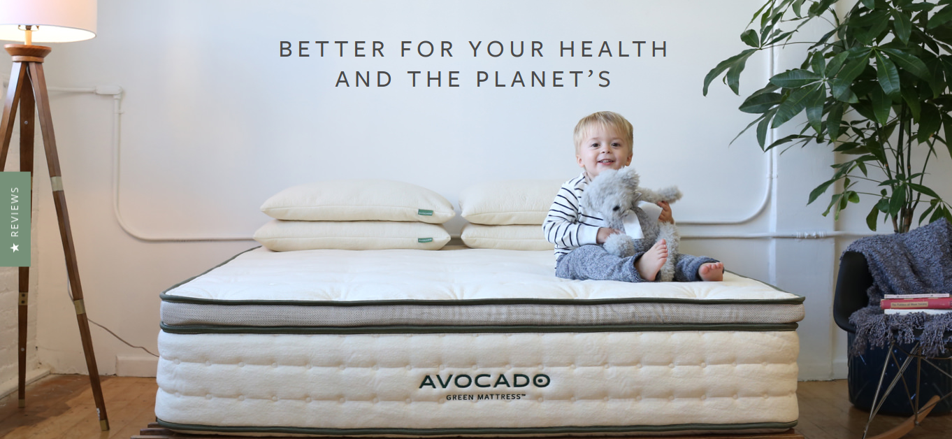 Photo of Avocado's organic mattress with baby sitting on top. 